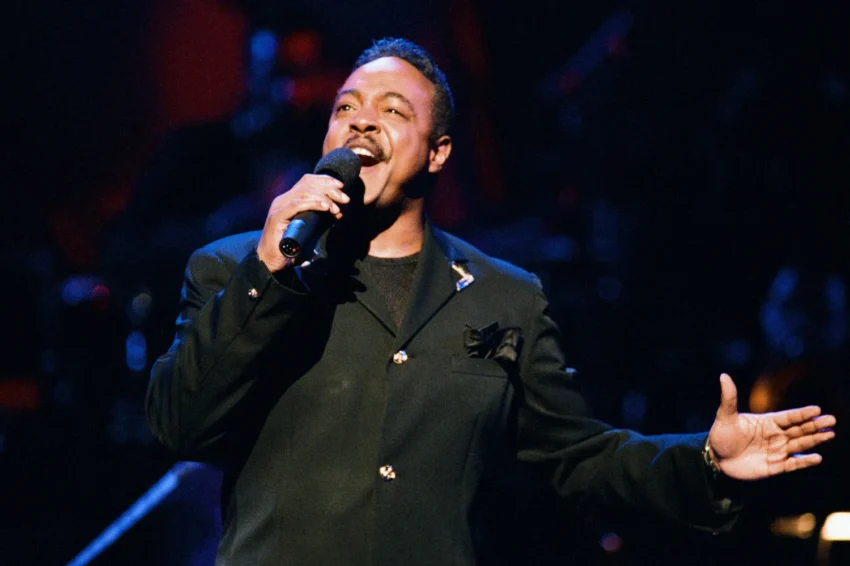 Peabo Bryson performing on stage during a live concert appearance.