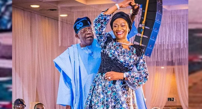President Bola Tinubu speaking at the Presidential Press Corps Dinner while acknowledging First Lady Oluremi Tinubu.