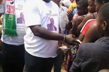 Vote Buying in Nigeria: Why It Persists and How It Affects Elections A Nigerian voter casting a ballot while election officials monitor proceedings, illustrating the importance of free and fair elections.